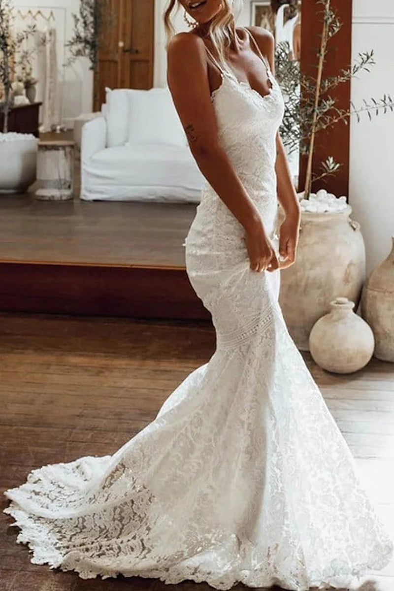 Full view of a Boho Mermaid Trumpet Lace Wedding Dress with spaghetti straps and V-neck.