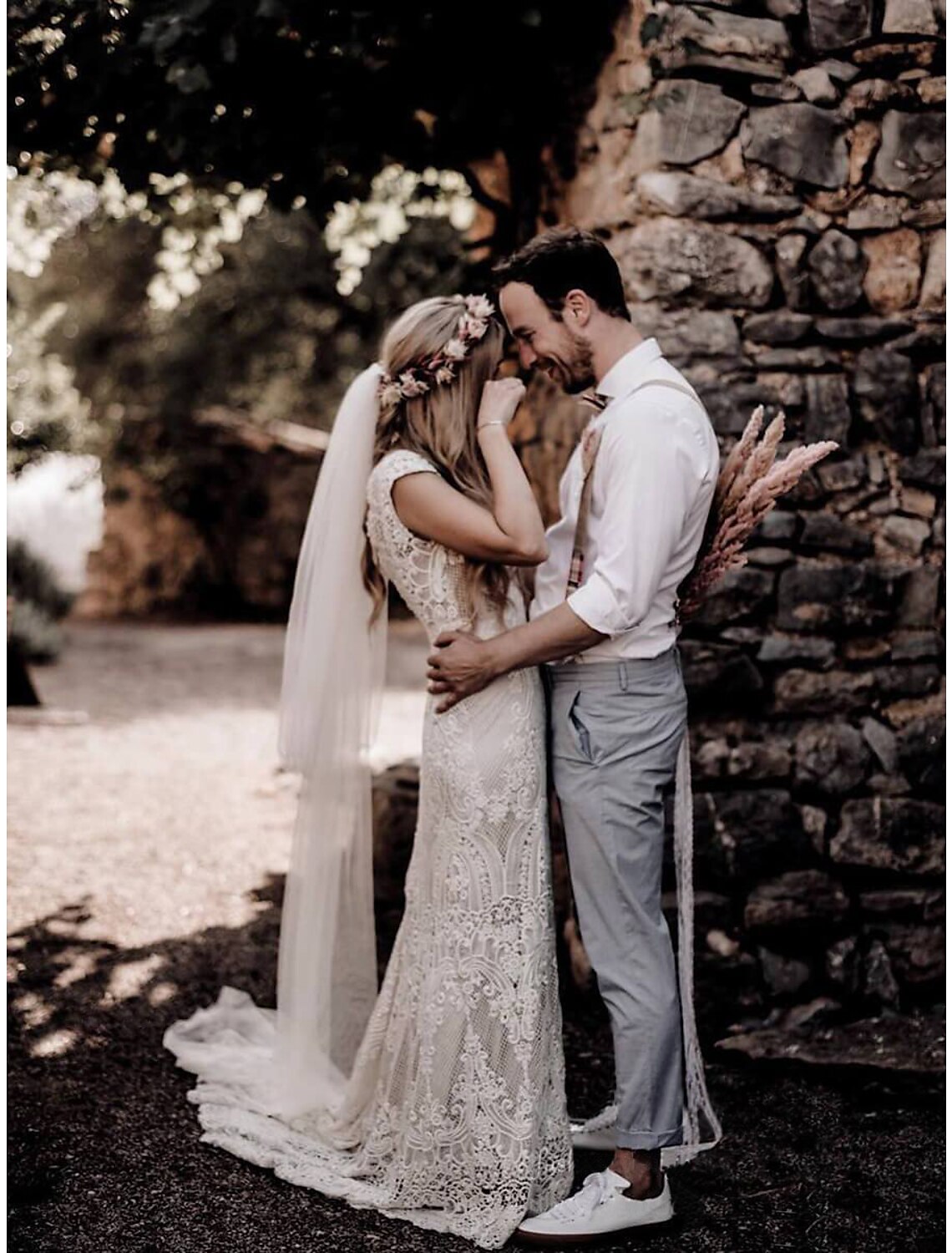 Back view of a lace applique bridal gown with court train.
