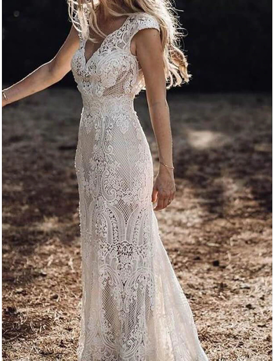 Close-up of intricate lace appliques on a wedding dress.