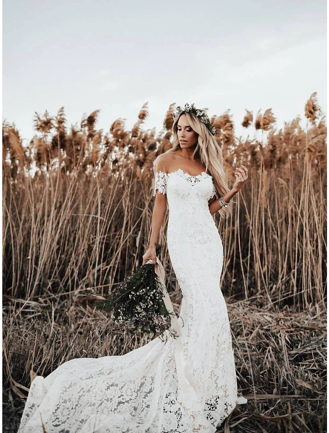Boho mermaid wedding dress with off-shoulder cap sleeves and chapel train.