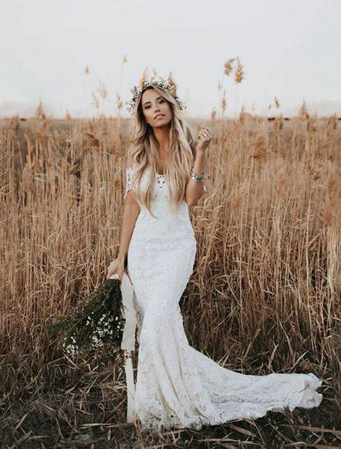 Back view of the elegant lace wedding gown with a flowing chapel train.