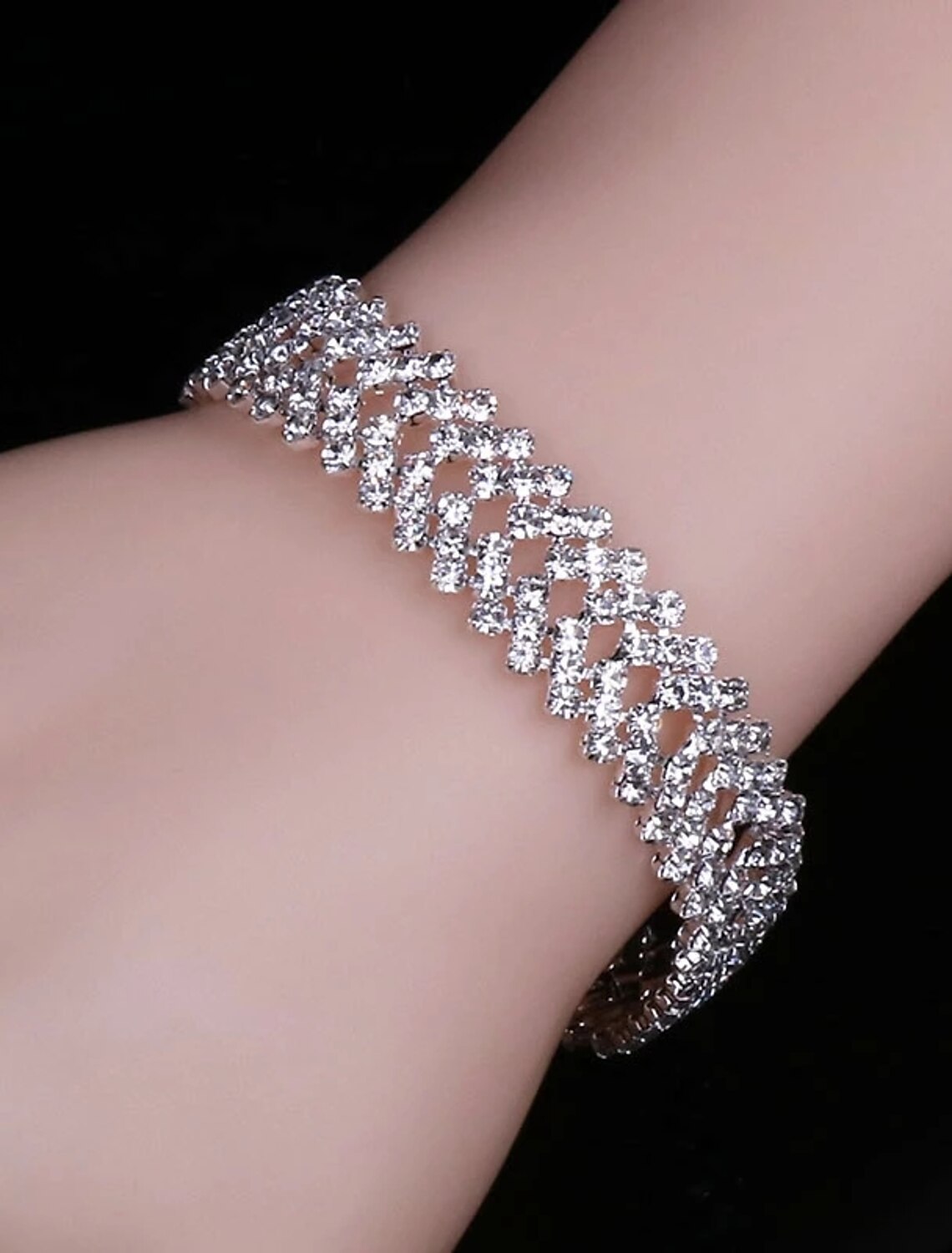 Close-up of the alloy bridal necklace and matching earrings on a woman.