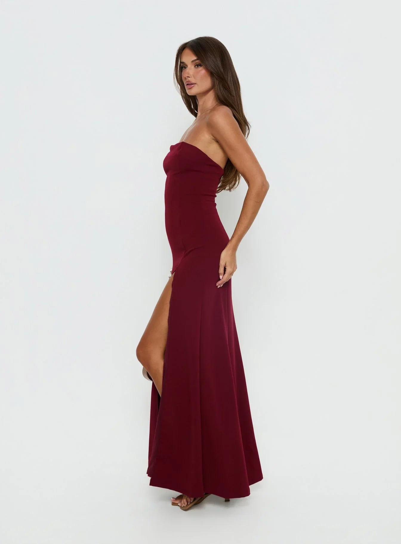 Burgundy Strapless Prom Dress with Front Slit and Form Fitting Silhouette for Formal Events and Prom Nights