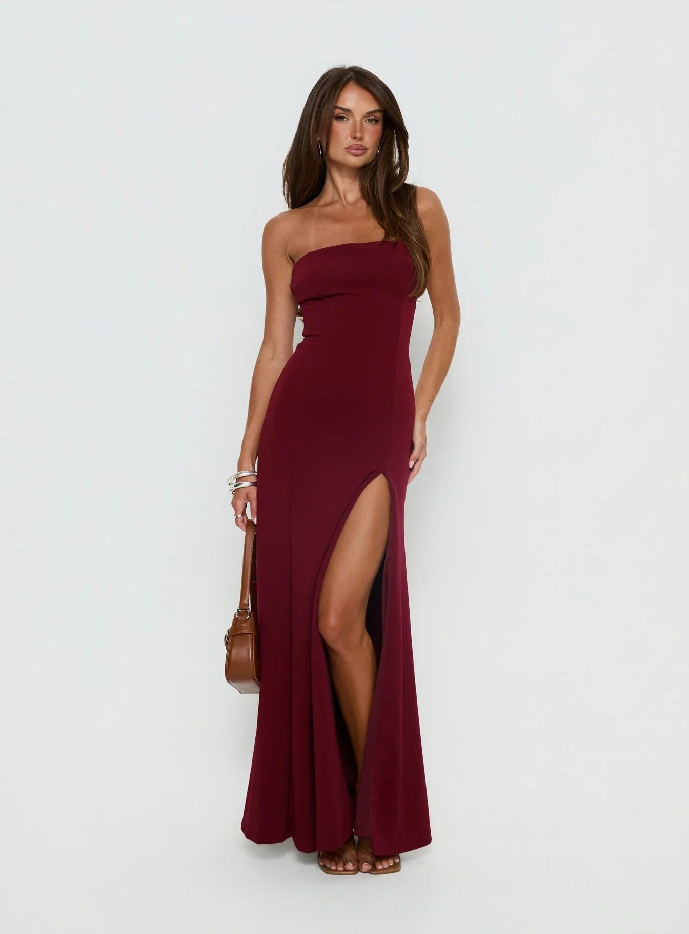 Burgundy Strapless Prom Dress with Front Slit and Form Fitting Silhouette for Formal Events and Prom Nights