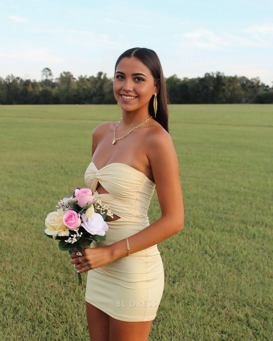 Model wearing a butter yellow strapless satin mini dress with double knot cutout.