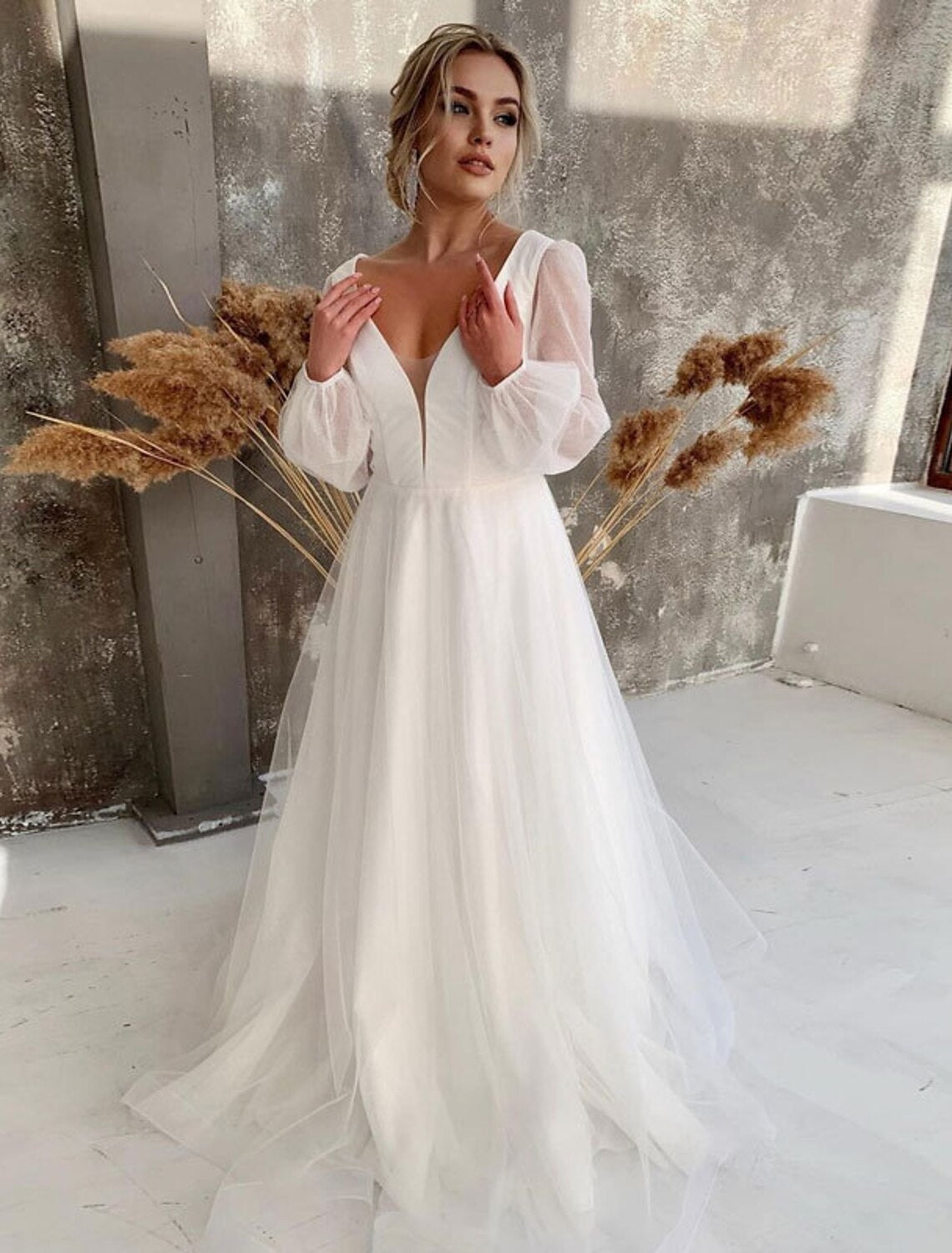 White A-line V-neck long sleeve tulle wedding dress.