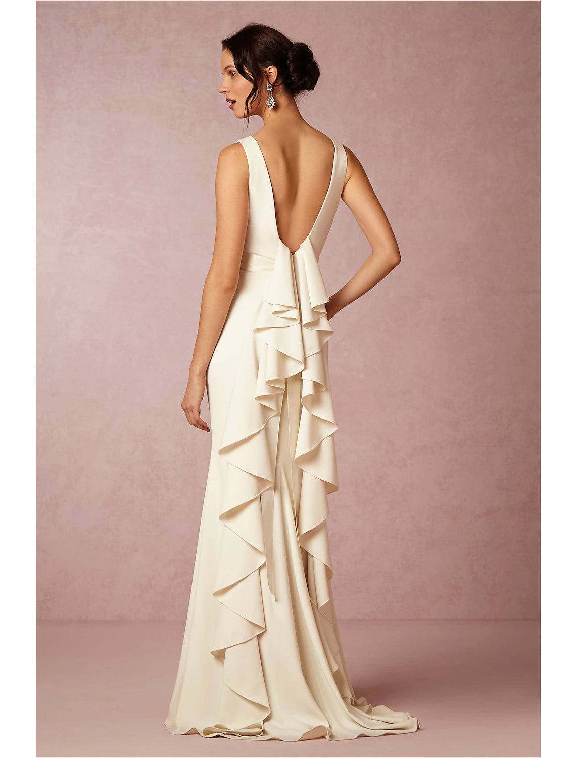 Side view of sheath wedding gown showing sweep train and draping.