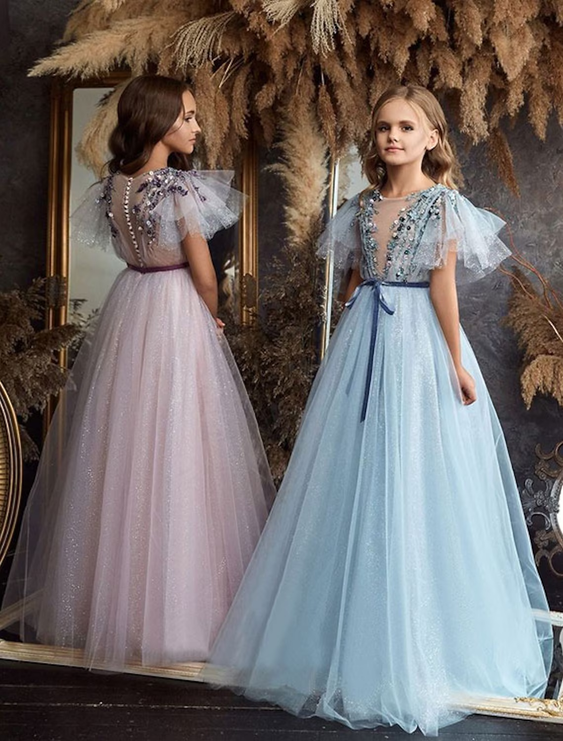 A-Line floor-length flower girl dress in light color with delicate appliques.