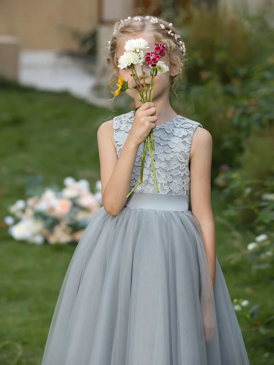 Front view of a charming A-line tulle flower girl dress with crew neck, applique, and sash.