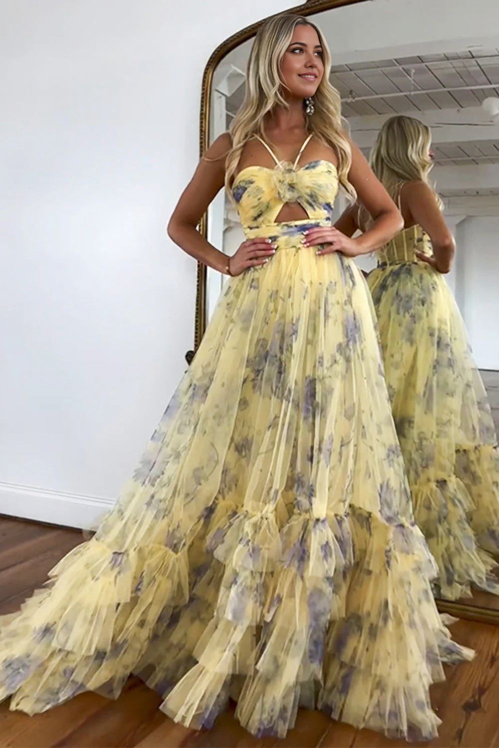 Side view of a long yellow halter neck evening gown with flowing tulle.