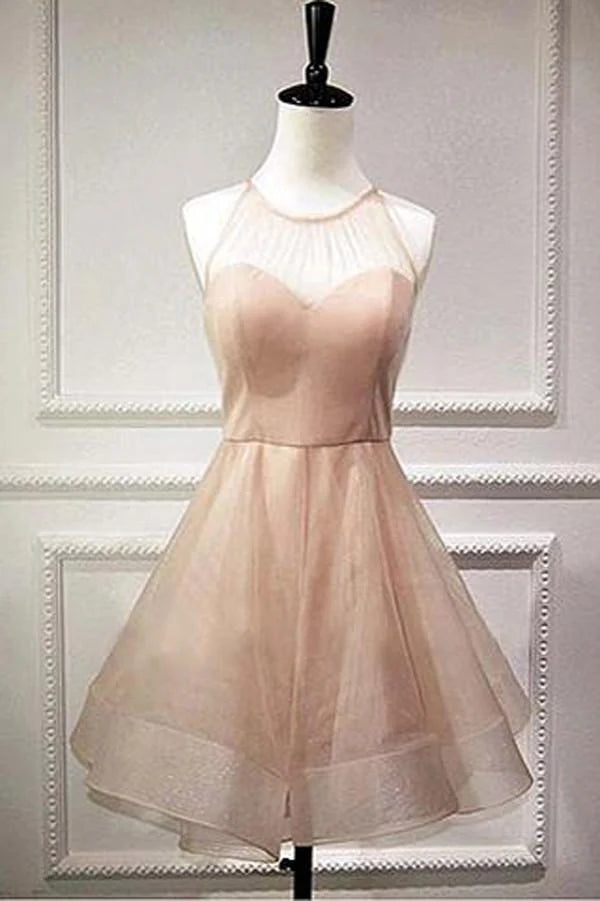 Woman wearing an elegant A-line halter tulle dress with a lace-up back, suitable for homecoming.