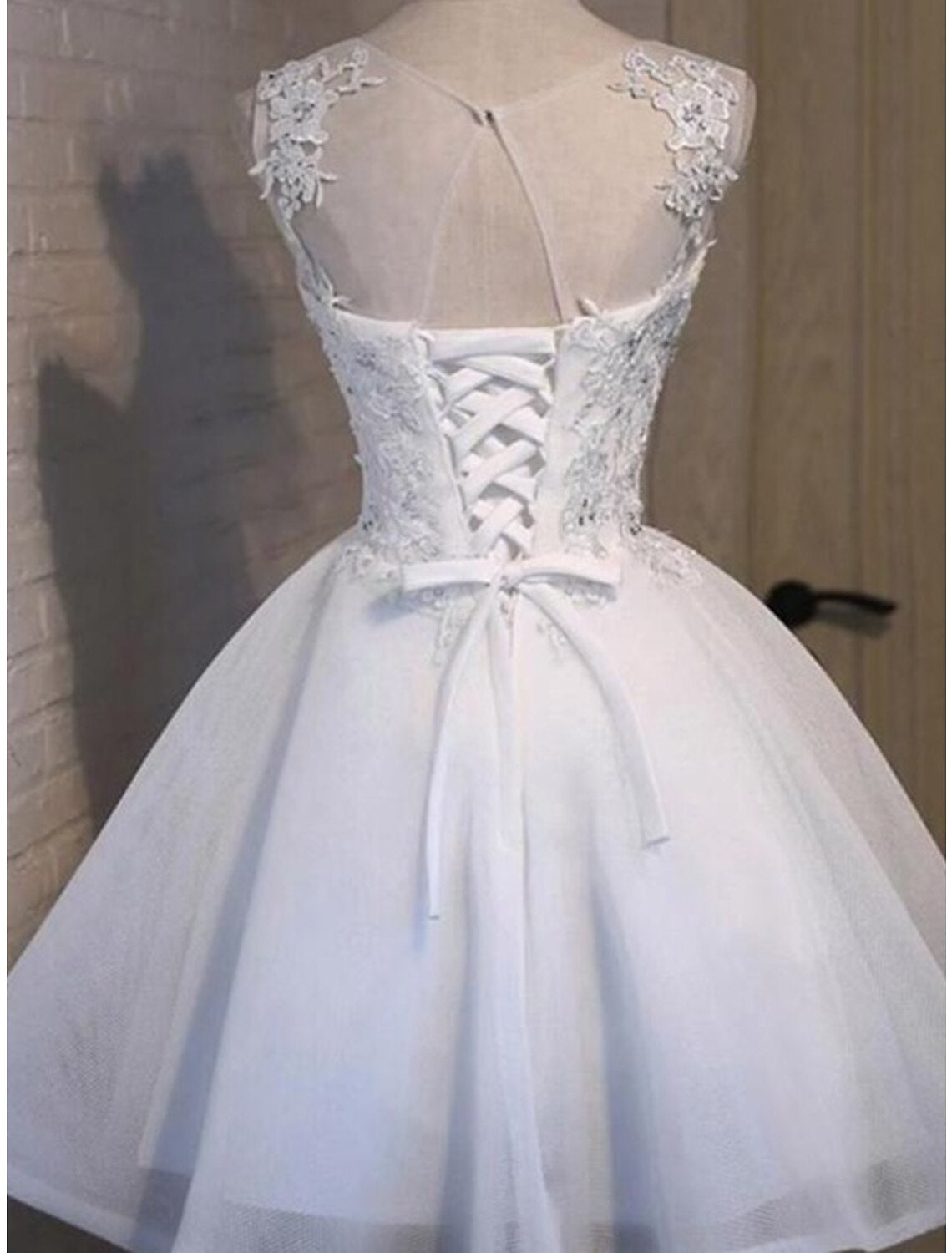 Side view of the elegant A-line short dress featuring floral appliques.
