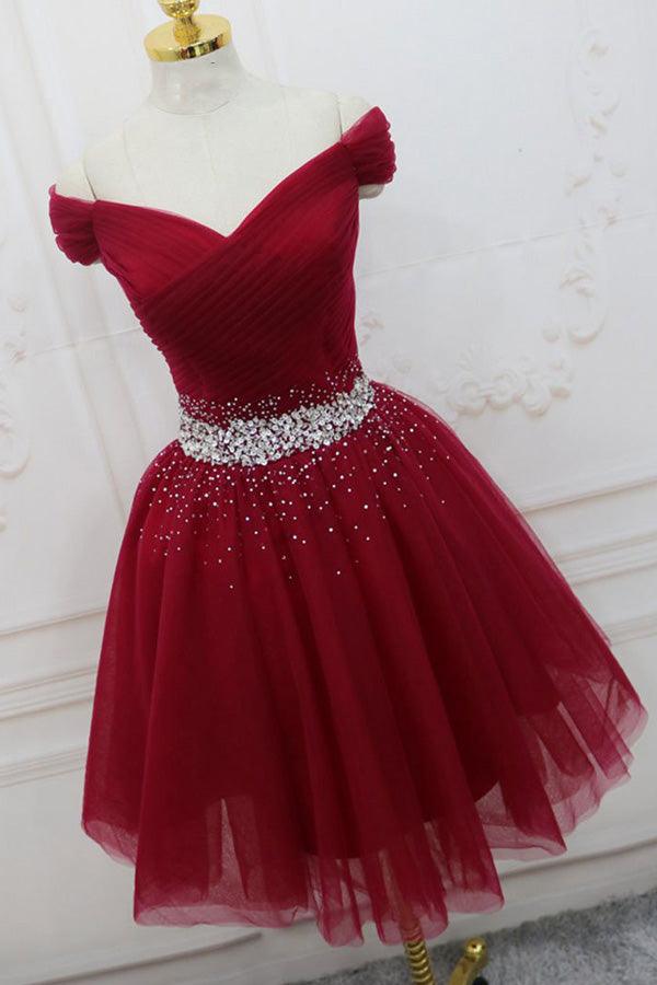 Close-up of the beaded bodice on an off-shoulder tulle dress.