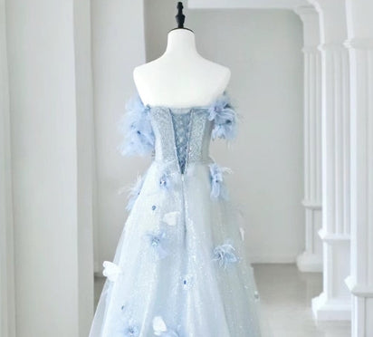 Detail of the floral applique on the tulle fabric of the prom dress.
