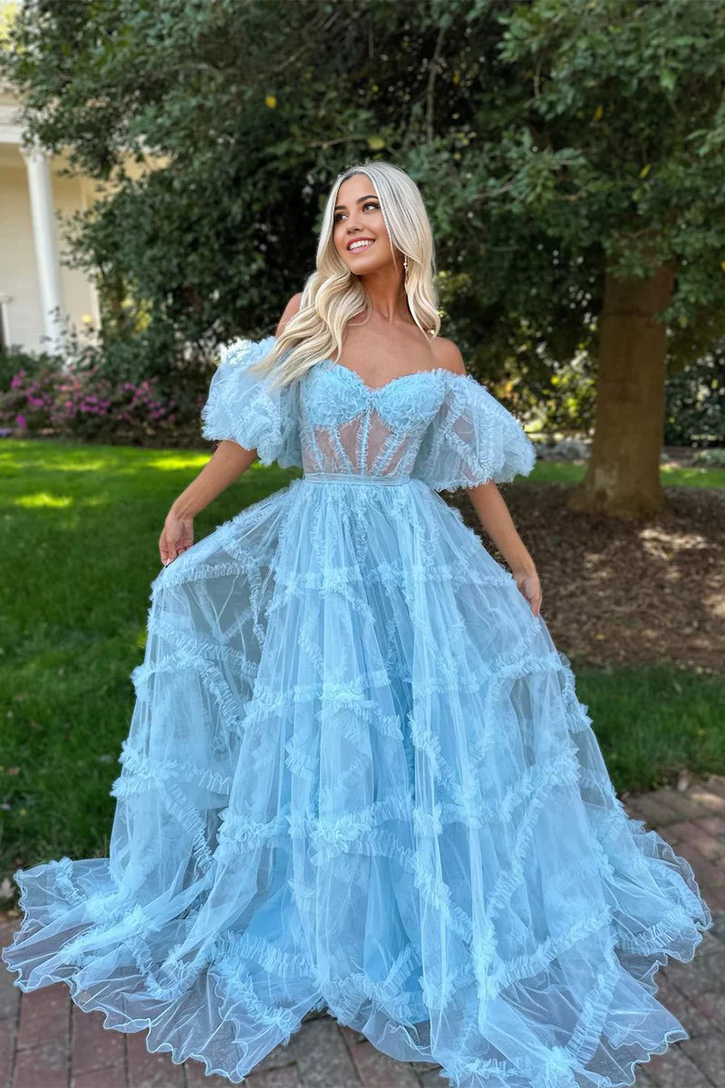 Model wearing a charming blue A-line off-the-shoulder tulle prom dress.