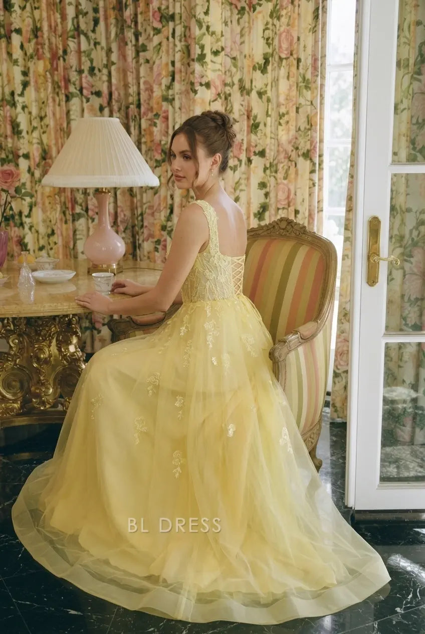 Back view of yellow A-line gown with lace-up closure.