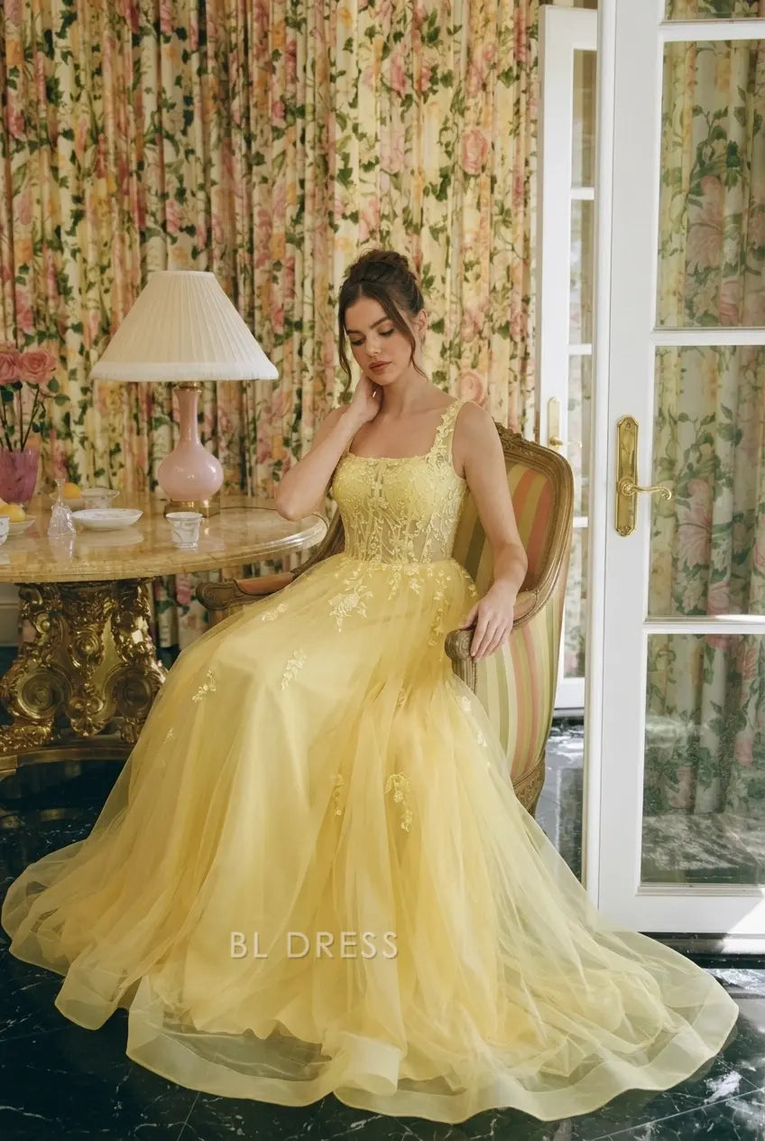Close-up of floral embroidery on yellow gown bodice.