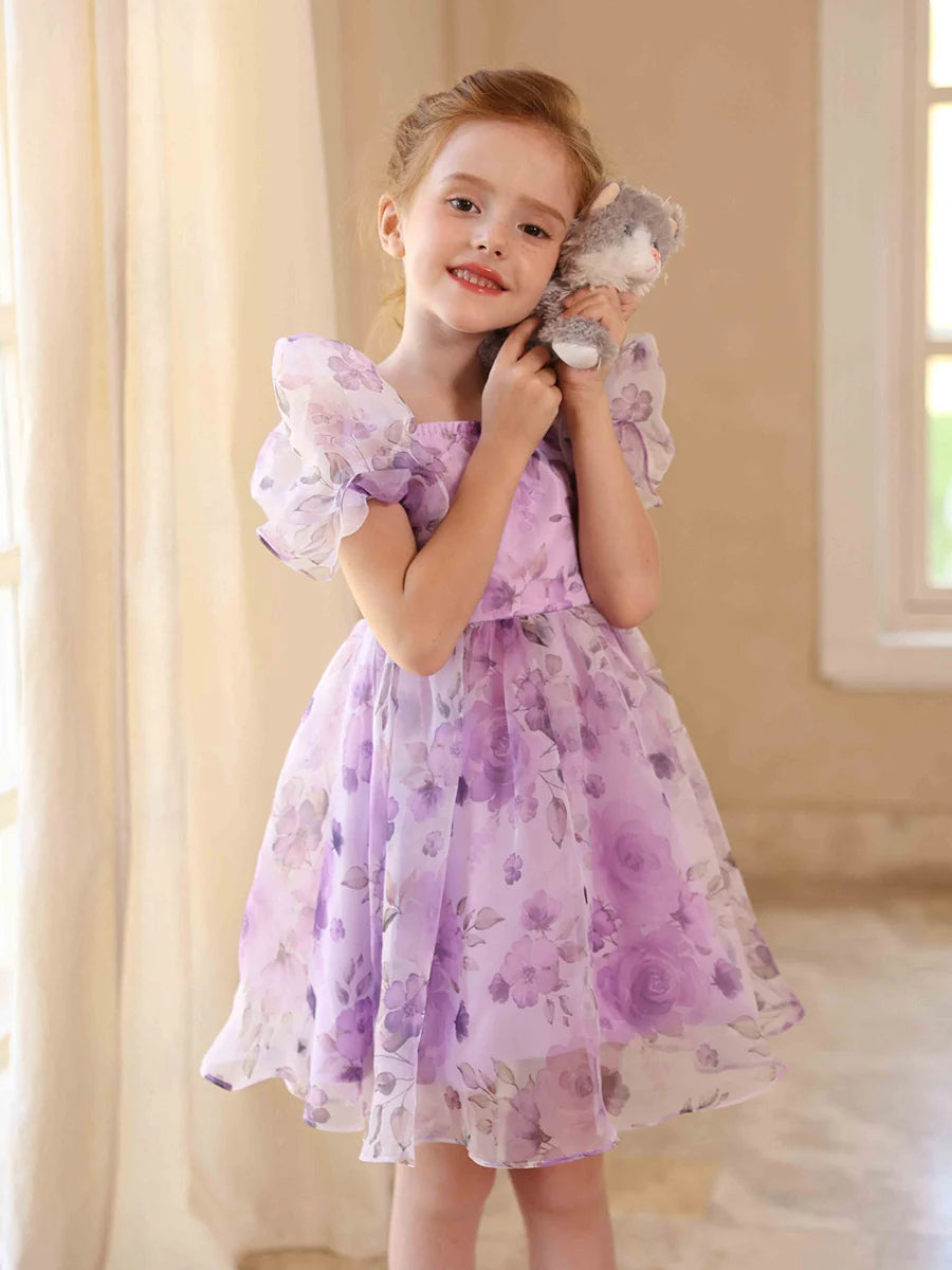 Close-up of the delicate floral print on the flower girl dress.