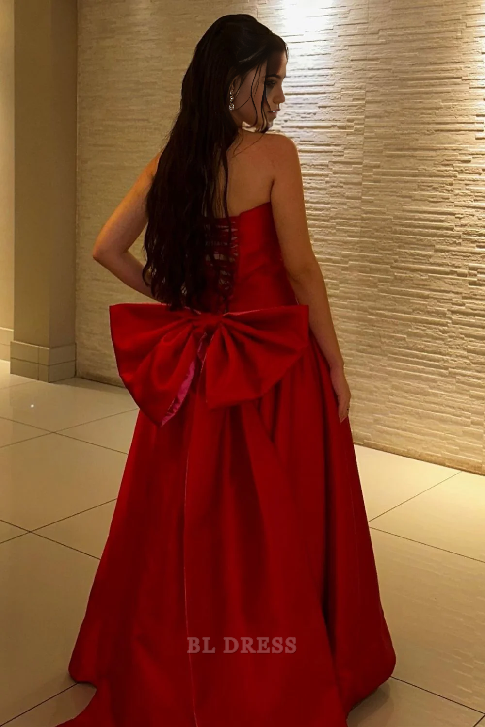 Back view of a red A-line strapless long formal dress with a bowknot.