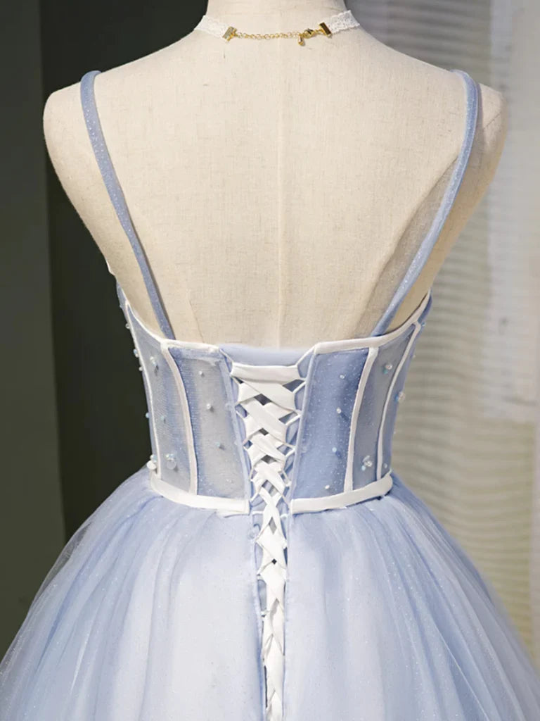 Back view of a model in a short tulle prom dress with sweetheart neckline.