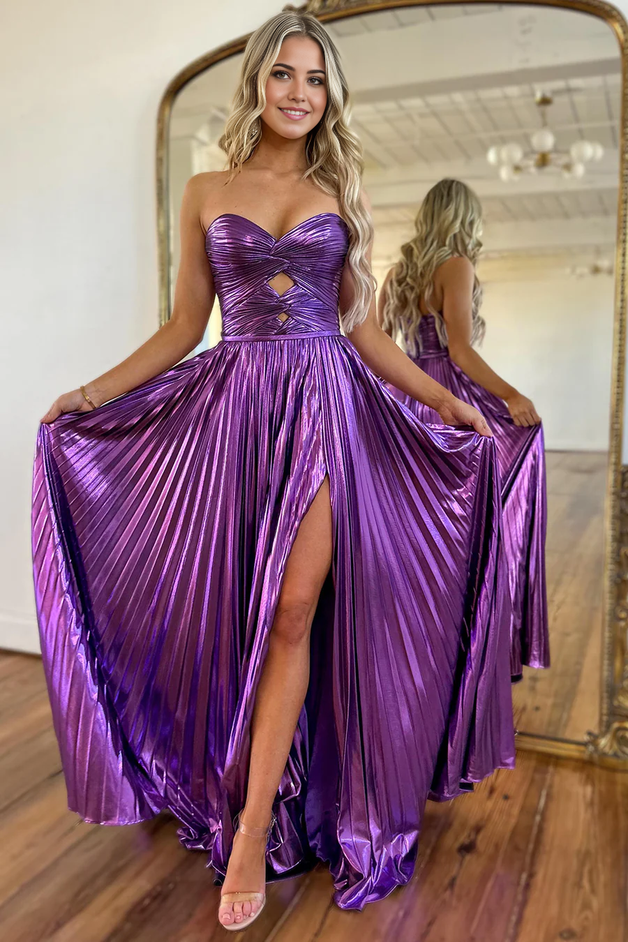 Front view of a purple A-line pleated satin formal dress with a sweetheart neckline and a side slit.