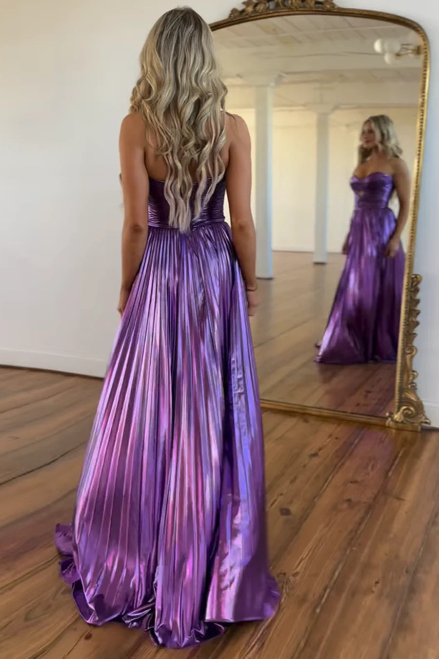 Back view of the elegant purple A-line pleated satin evening gown.