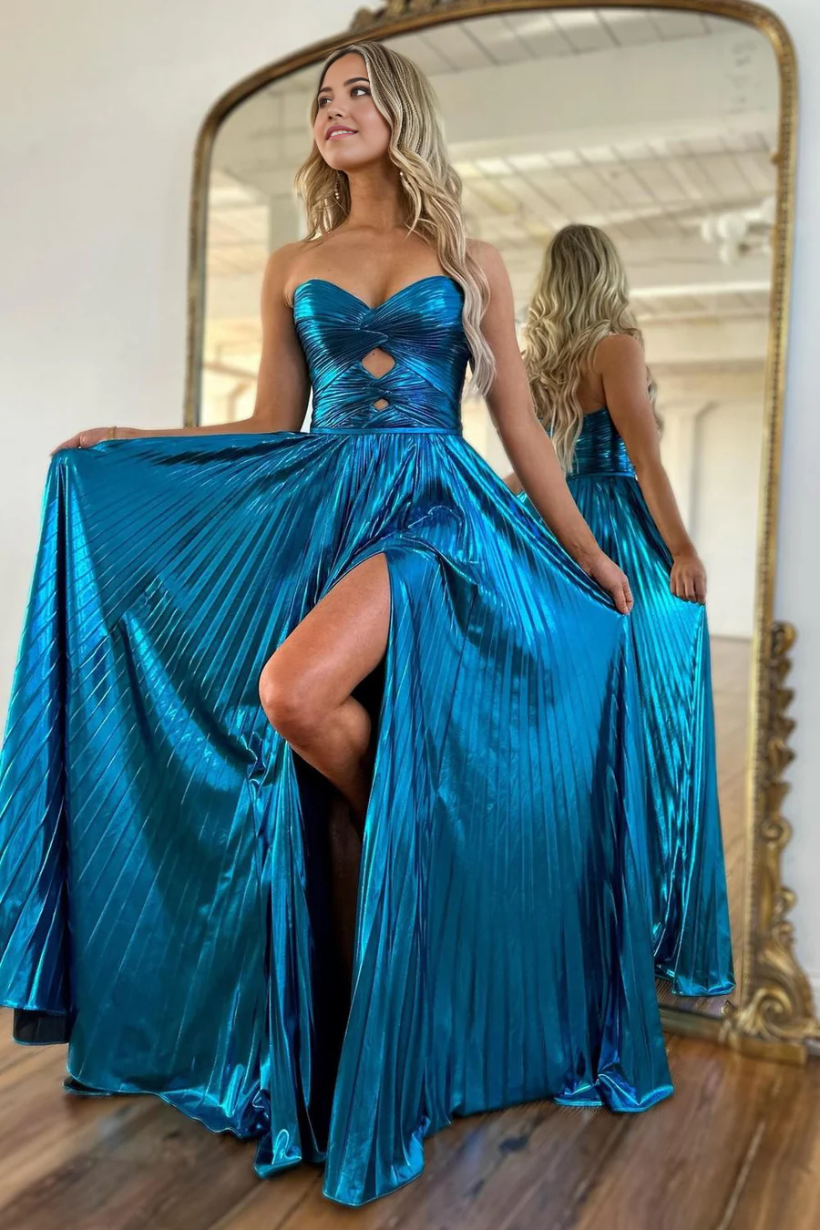 Side view of the purple A-line prom dress, showcasing the flowing pleated satin and high slit.