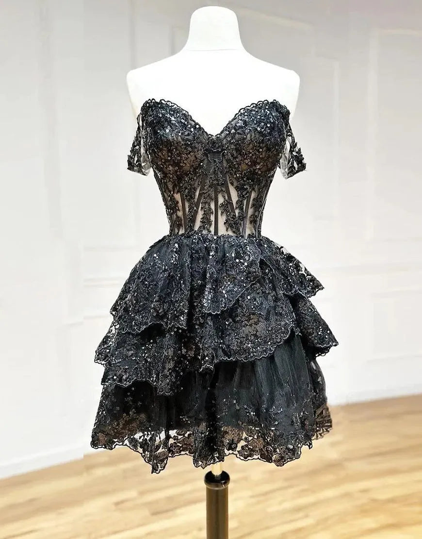 Navy A-line tiered short homecoming dress with appliques, front view.