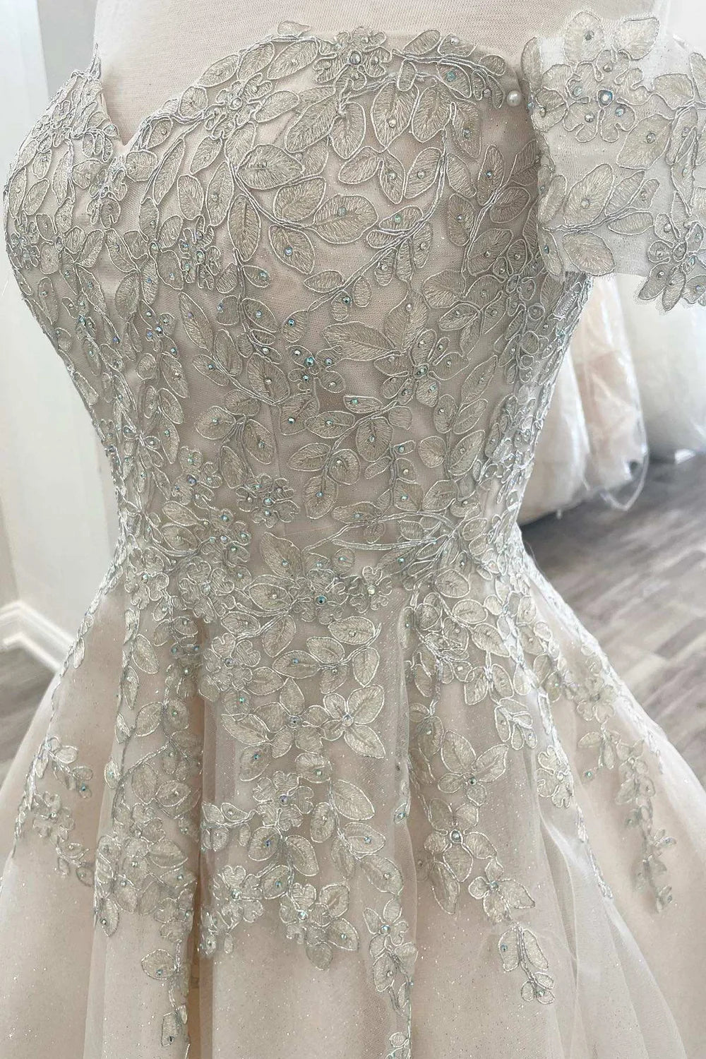 Close-up of delicate appliques on the bodice of the short dress.