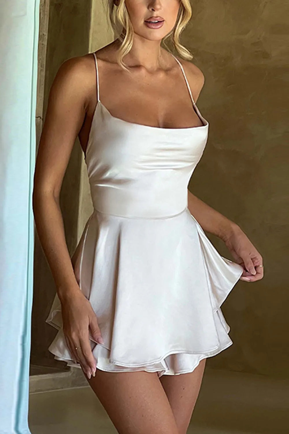 White A-line homecoming dress with spaghetti straps and V-neck.