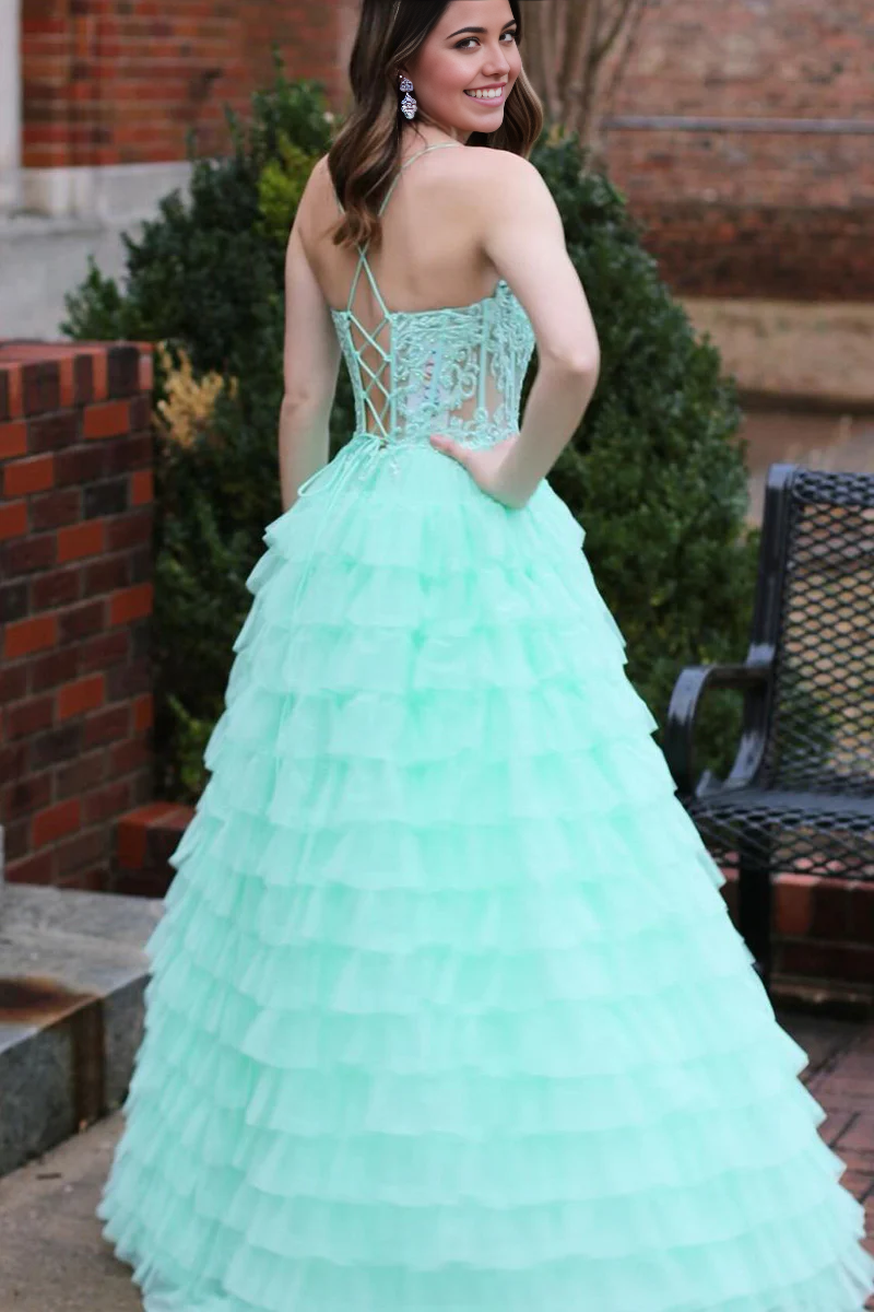 Side view of a mint A-line V-neck tiered tulle prom dress.