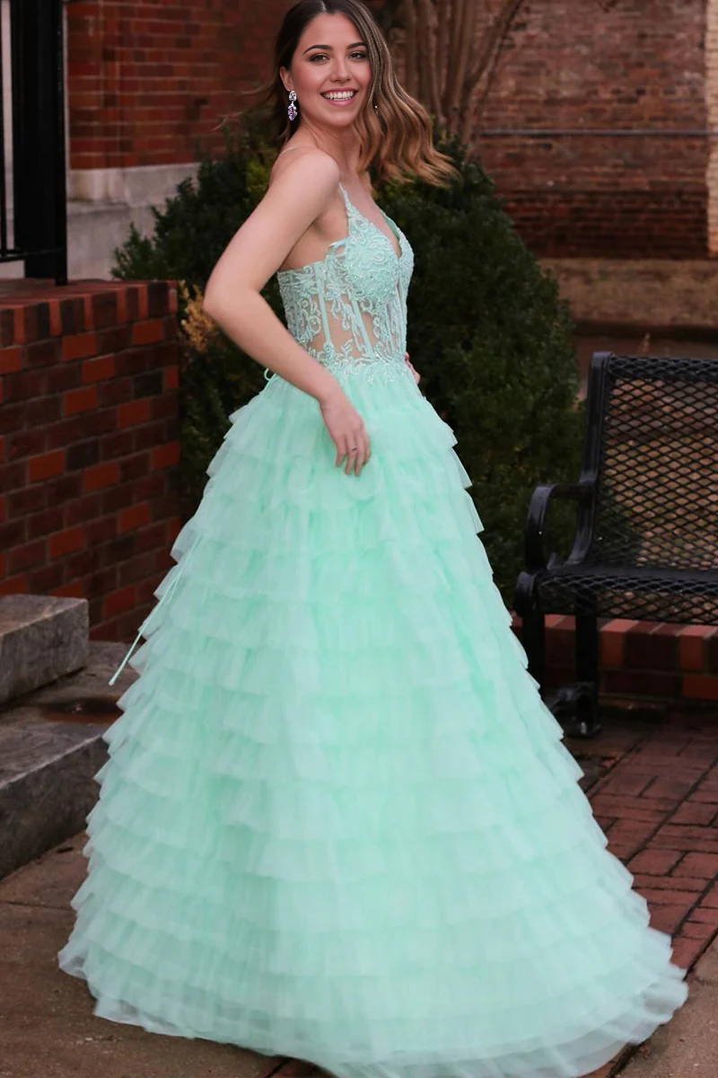 Back view of a mint A-line V-neck tiered tulle prom dress.