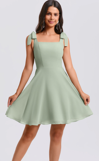 Model wearing a short A-line chiffon homecoming dress with square neckline and bow detail.