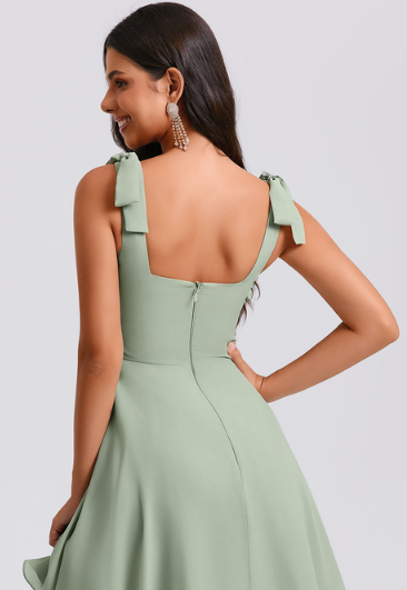Back view of the short A-line chiffon dress, highlighting the bow detail.