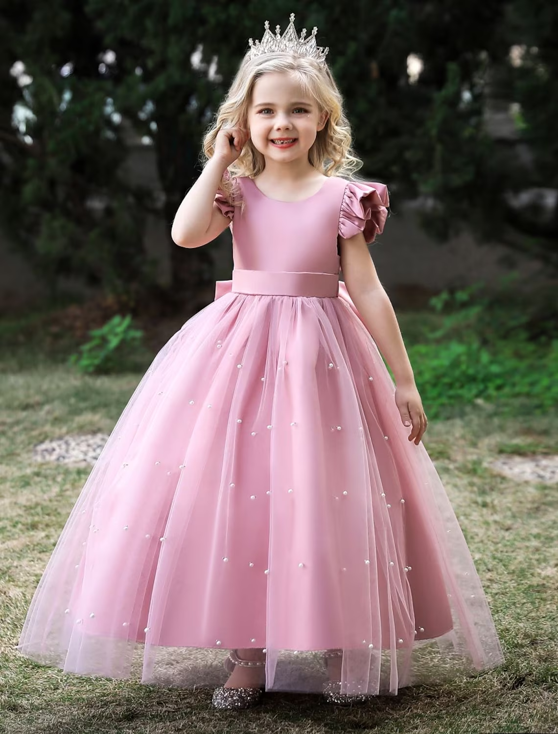 Young girl wearing a wine-colored sleeveless princess tulle maxi dress with a bow.