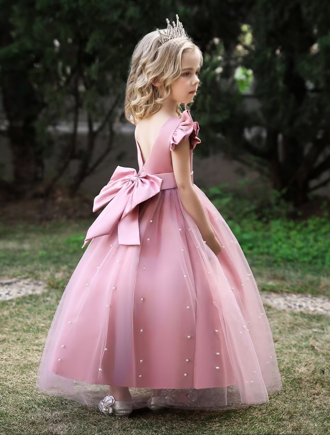 Close-up of the mesh and bow detail on a girls' princess dress.