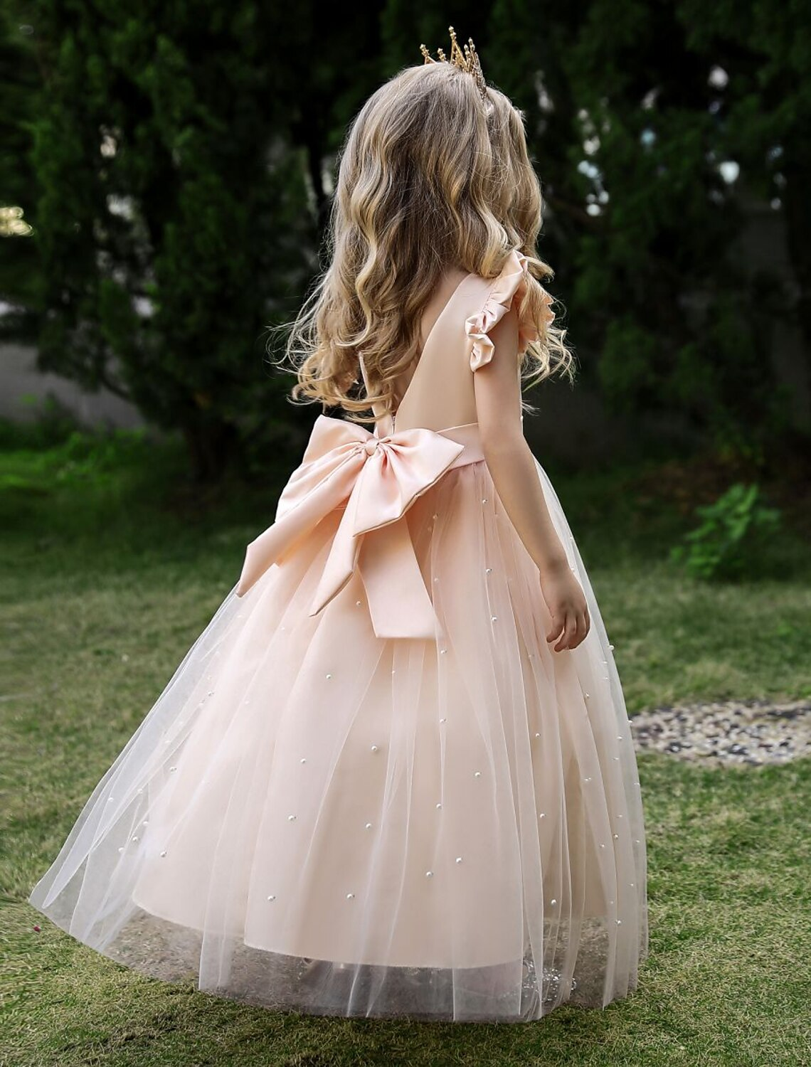 Side view of a girls' sleeveless princess tulle maxi dress in wine.