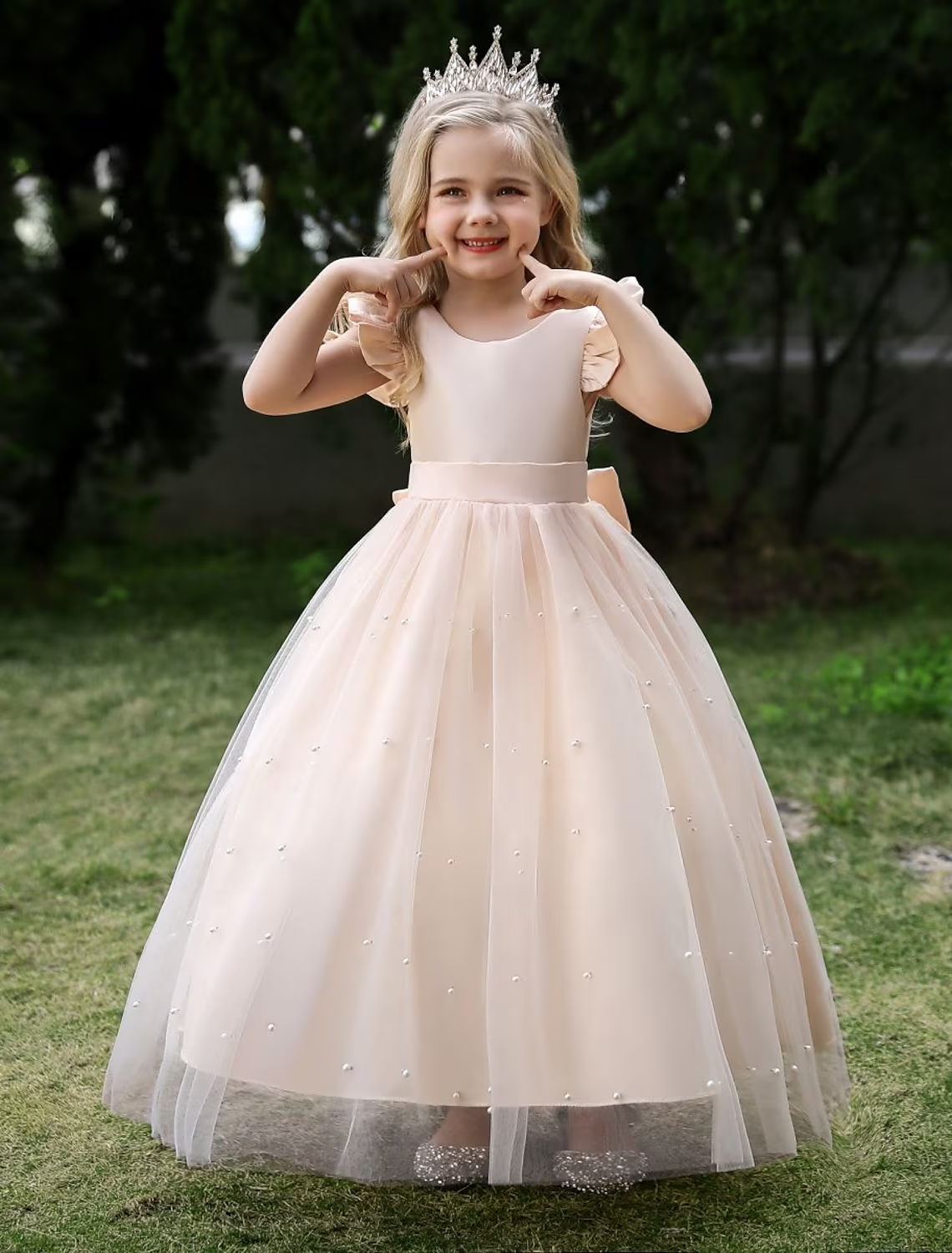Full length view of a girls' sleeveless princess tulle maxi dress in dusty rose.