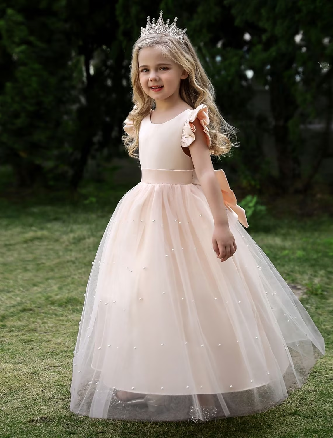 Full length view of a girls' sleeveless princess tulle maxi dress in gold.