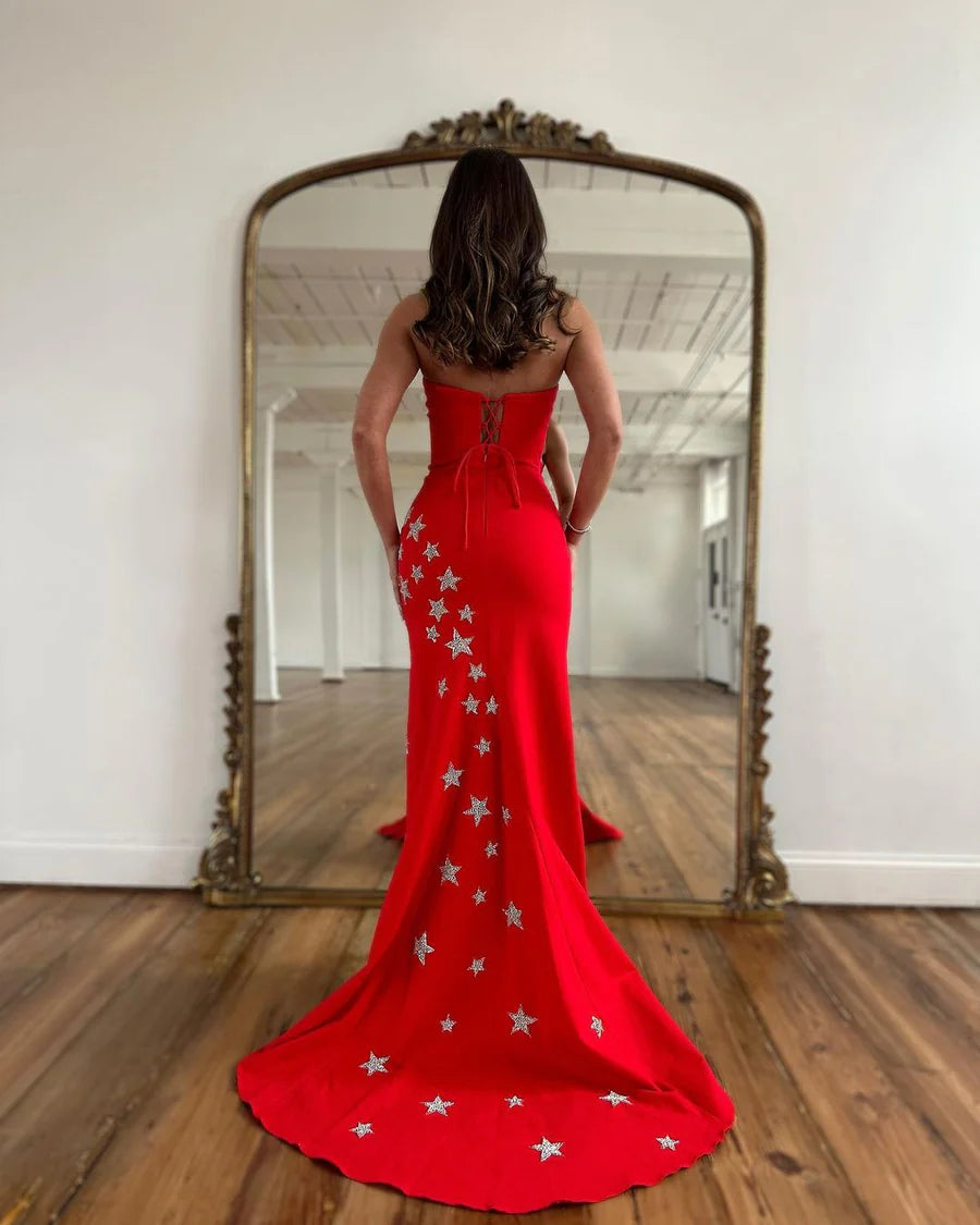 Back view of a charming red satin mermaid gown, featuring a strapless design.