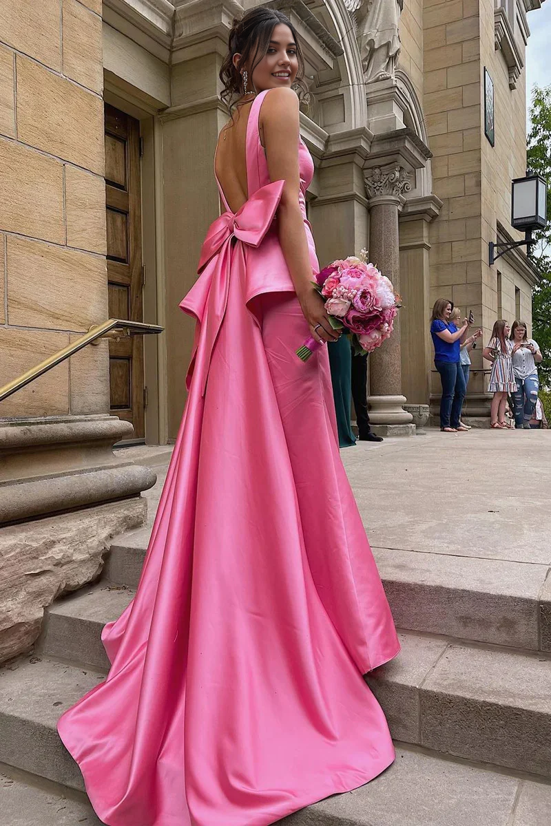 Pink satin sheath prom dress with sweetheart neckline and large back bow.