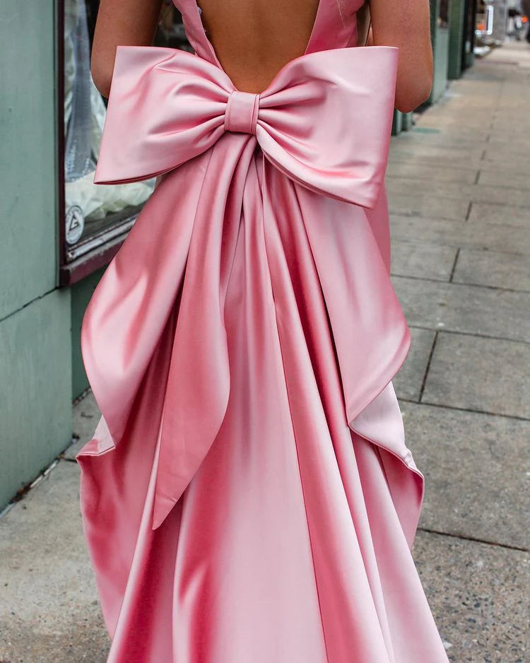 Side profile of the pink satin sheath prom dress.