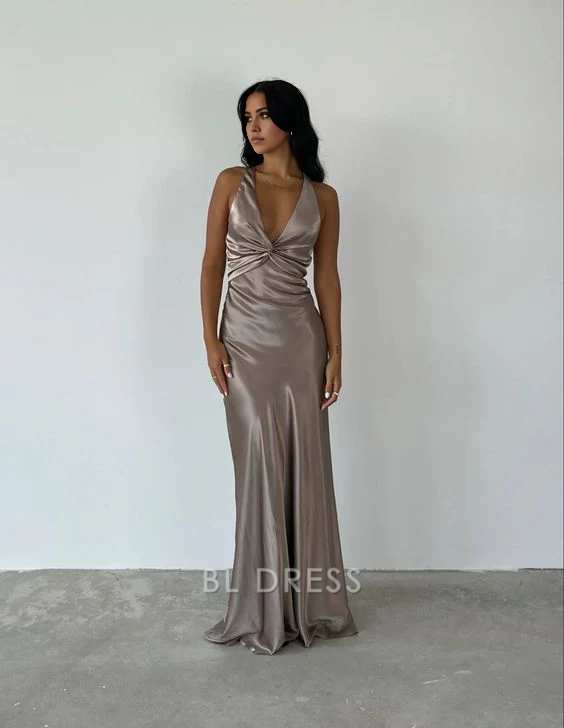 Woman wearing a long V-neck sheath formal dress.