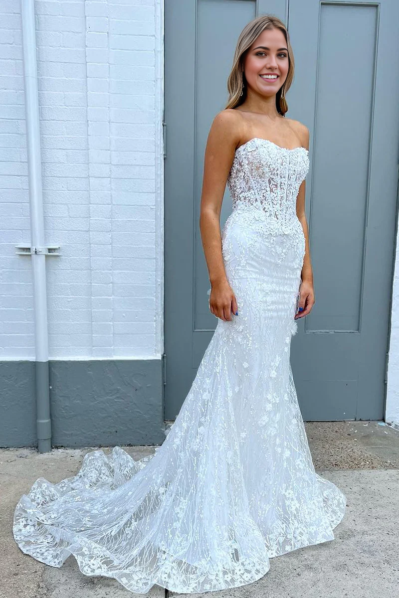 Model wearing a white sequin mermaid prom dress with a sweetheart neckline.