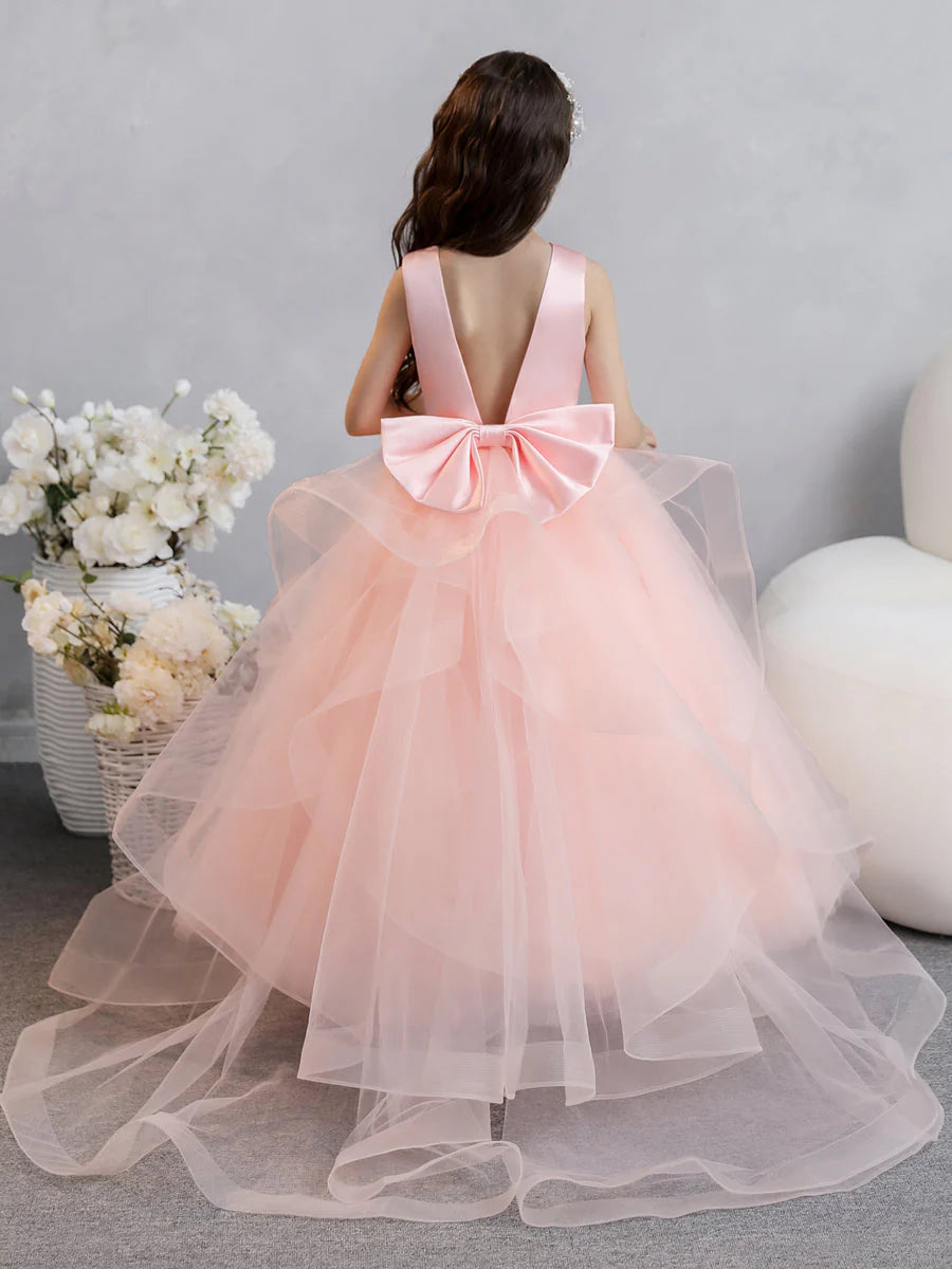Side view of a flower girl in a voluminous tulle ball gown.