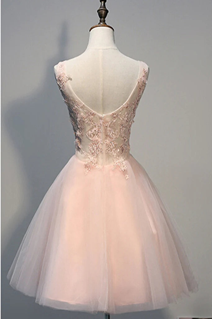 Close-up of short pearl pink homecoming dress with intricate appliques.