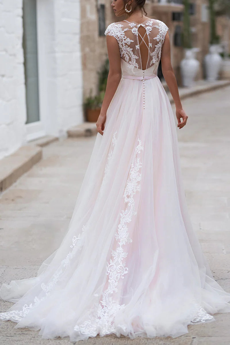 Chic A-line bridal gown with cap sleeves, side view.