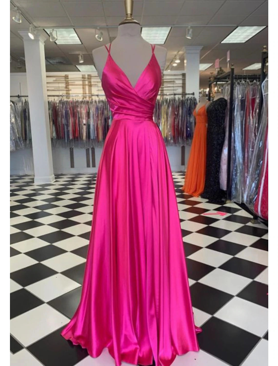 Elegant A-line charmeuse prom dress with spaghetti straps and a high slit, front view.