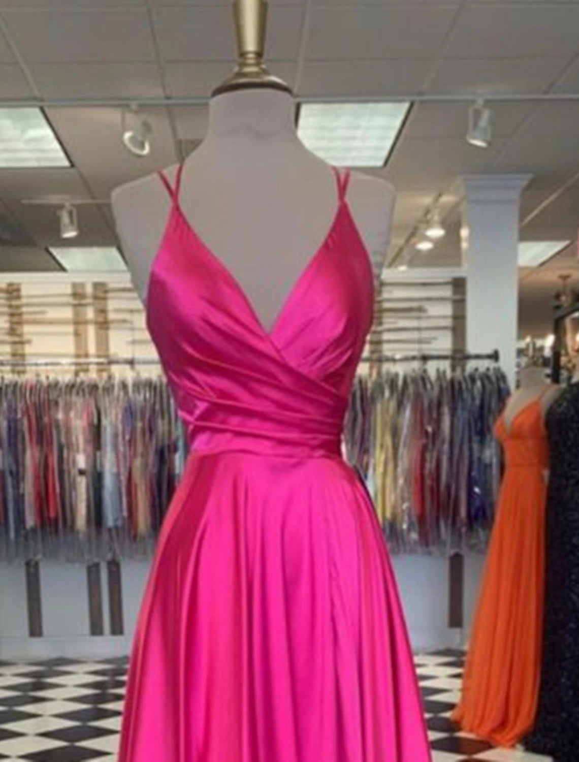 Side profile of the floor-length charmeuse gown, highlighting the slit detail.
