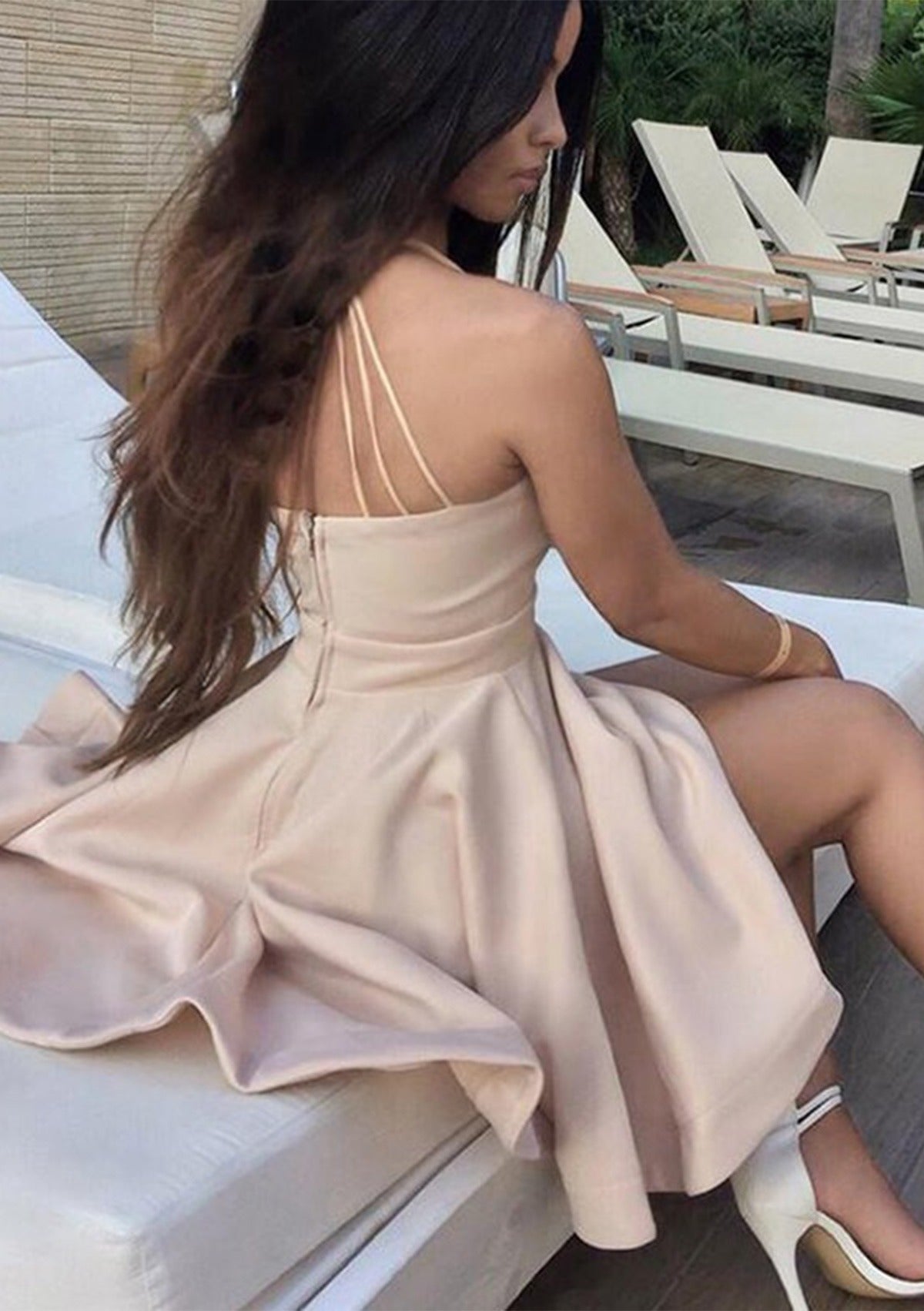 Back view of blush pink A-line dress with crisscross straps.